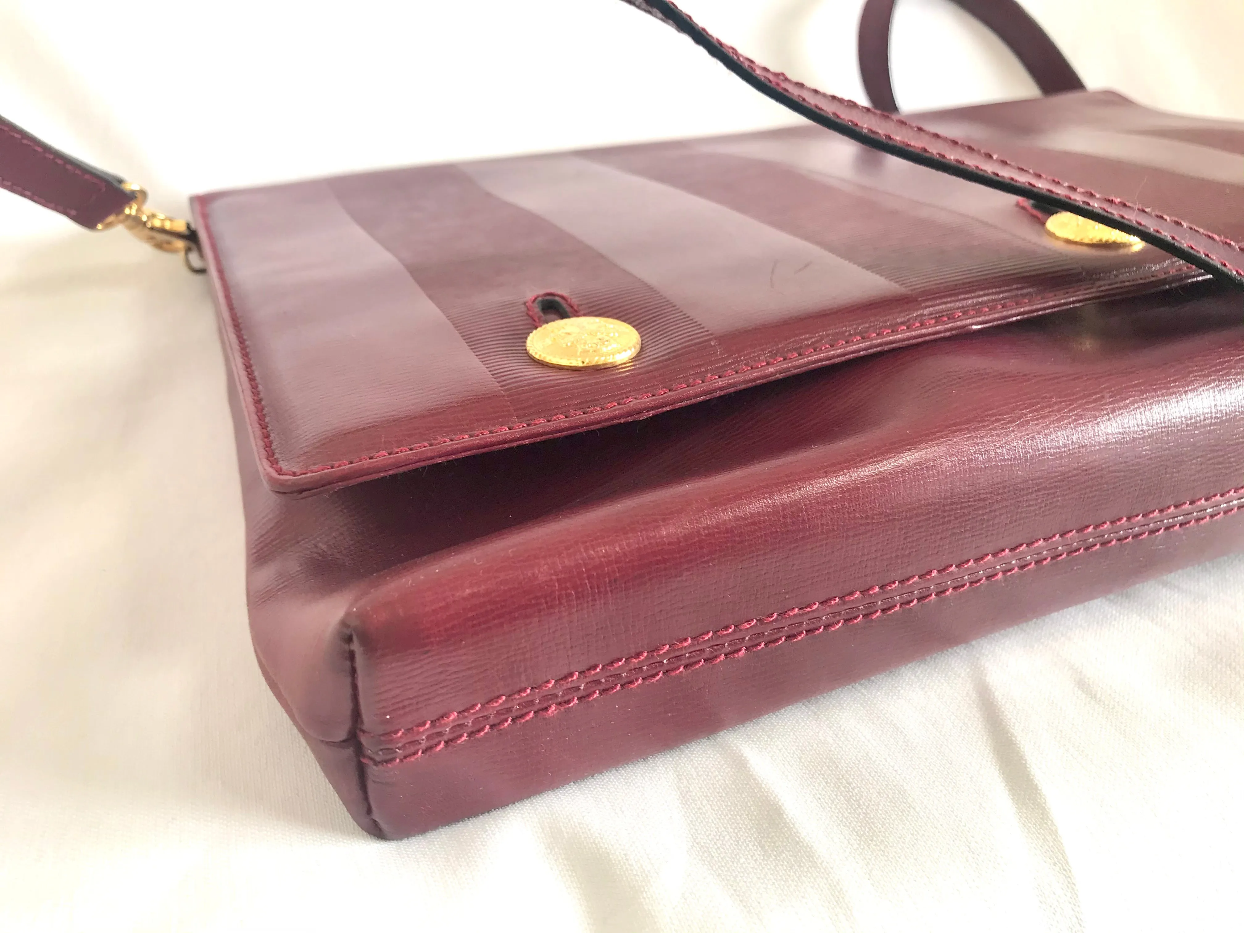 Vintage FENDI wine leather shoulder bag, large clutch purse with iconic Janus medallion embossed motifs at front. Unisex. 060620re5