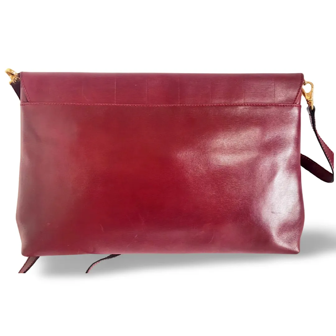 Vintage FENDI wine leather shoulder bag, large clutch purse with iconic Janus medallion embossed motifs at front. Unisex. 060620re5