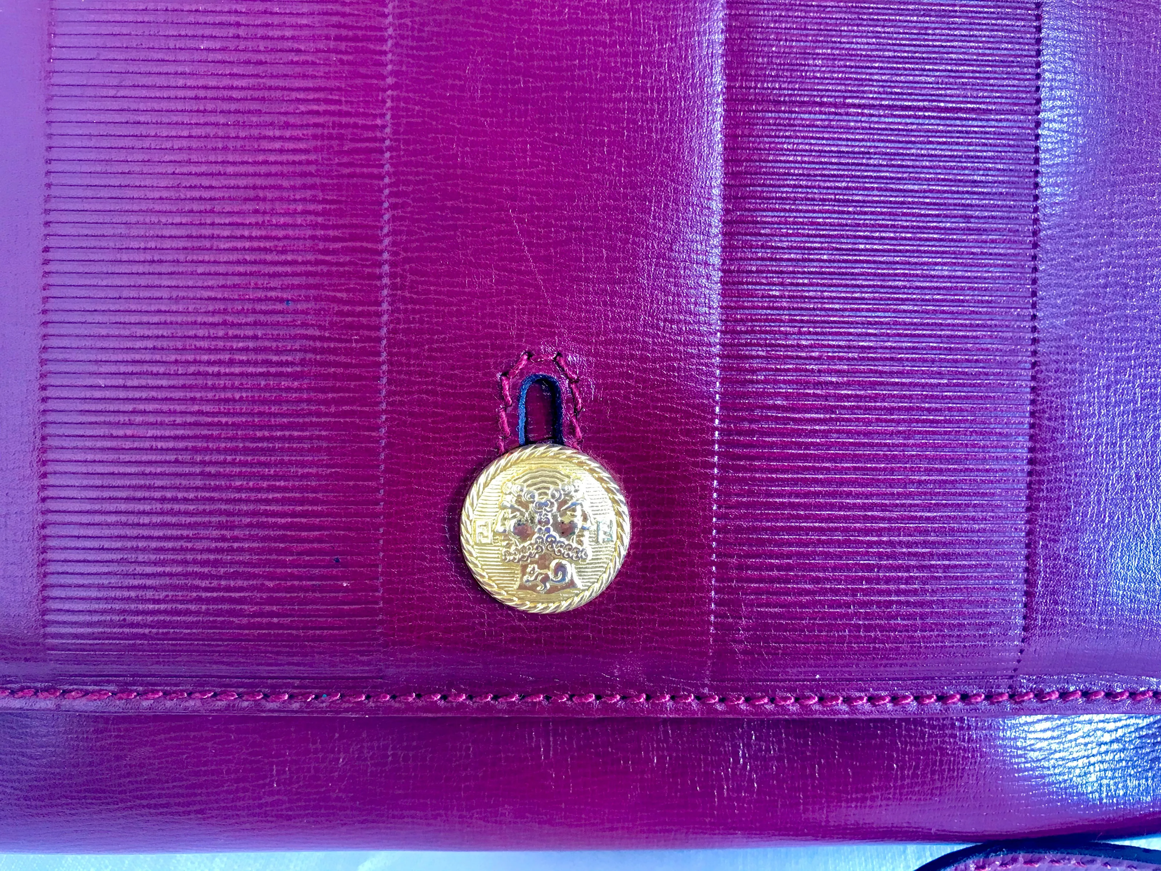 Vintage FENDI wine leather shoulder bag, large clutch purse with iconic Janus medallion embossed motifs at front. Unisex. 060620re5