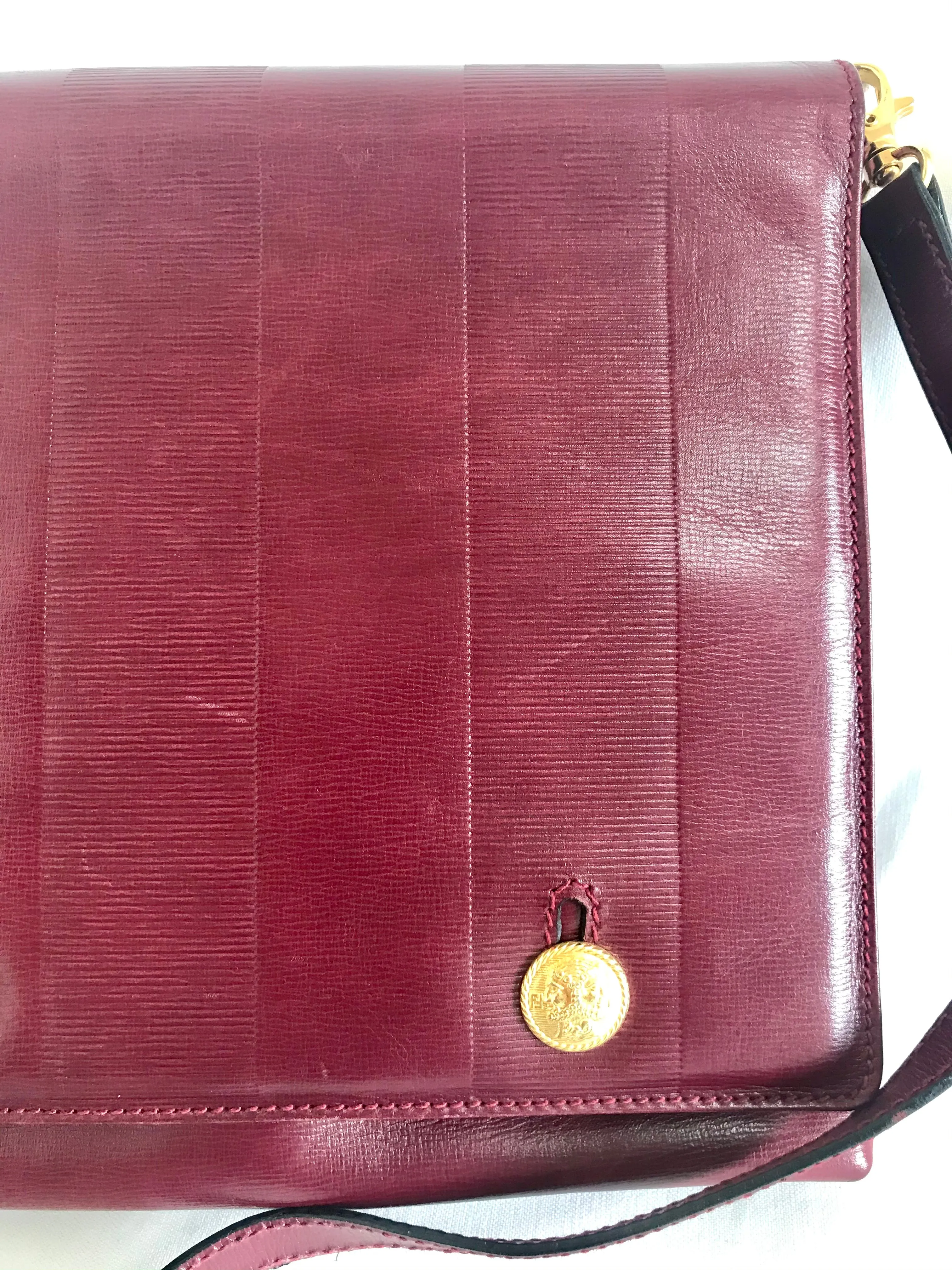 Vintage FENDI wine leather shoulder bag, large clutch purse with iconic Janus medallion embossed motifs at front. Unisex. 060620re5