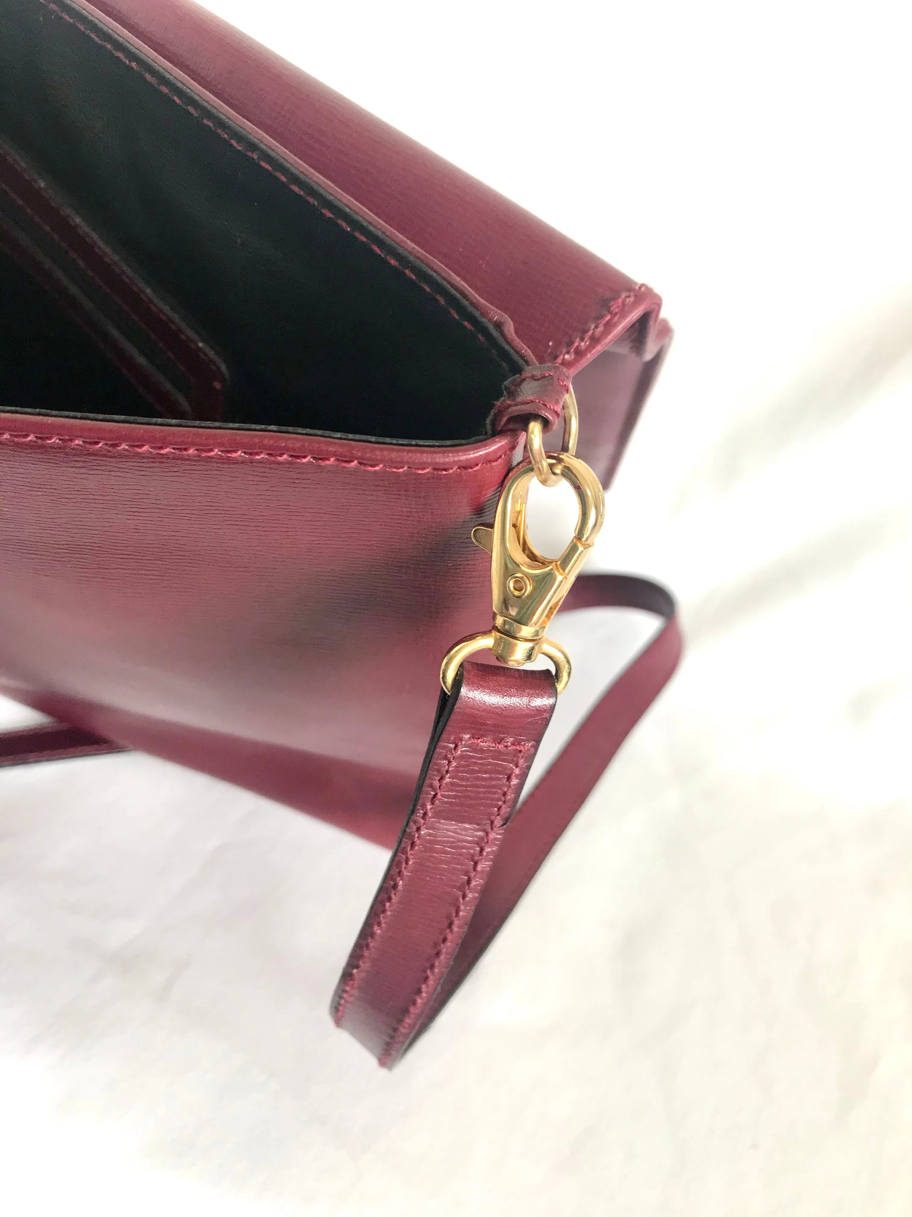 Vintage FENDI wine leather shoulder bag, large clutch purse with iconic Janus medallion embossed motifs at front. Unisex. 060620re5