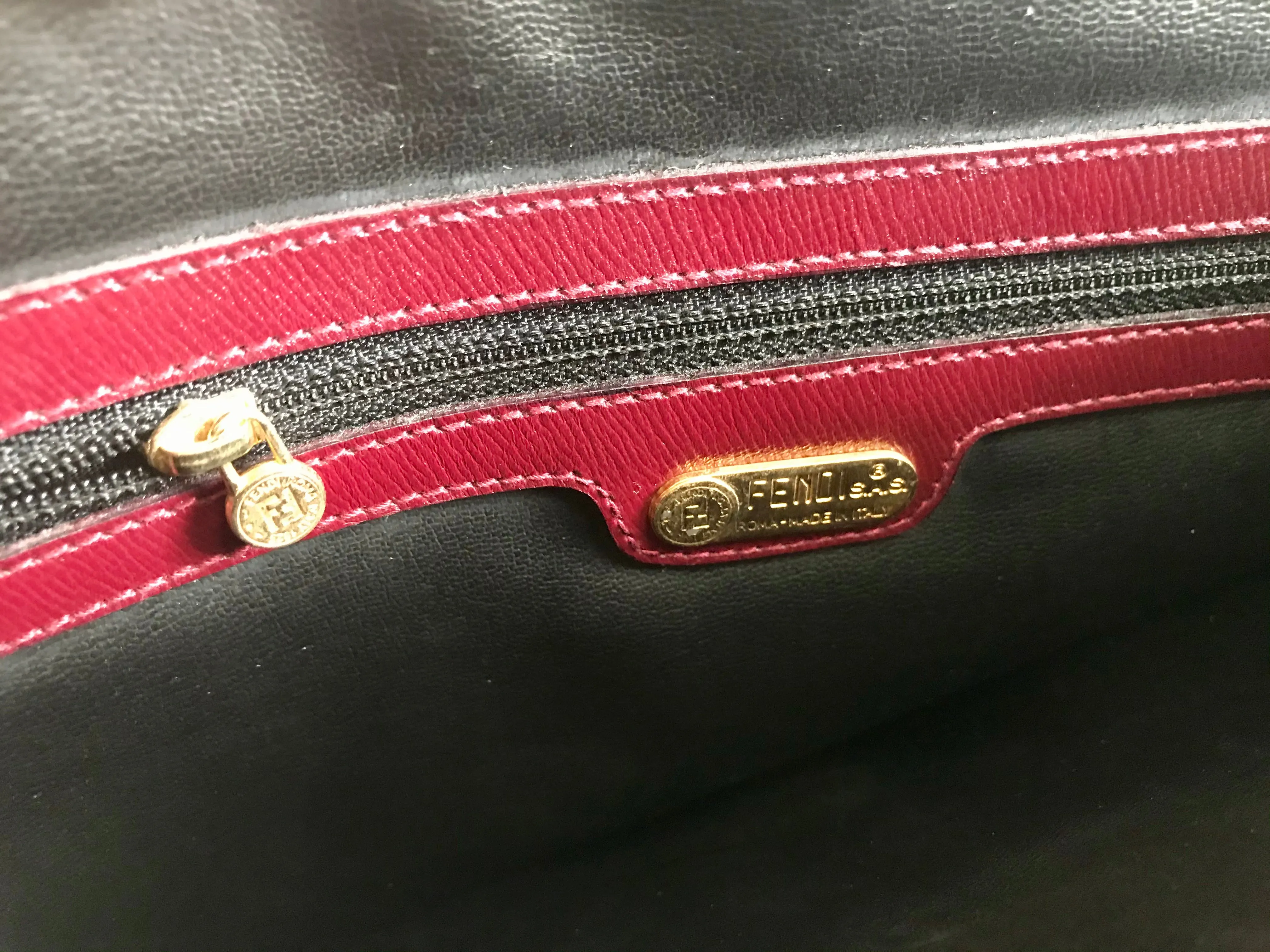 Vintage FENDI wine leather shoulder bag, large clutch purse with iconic Janus medallion embossed motifs at front. Unisex. 060620re5