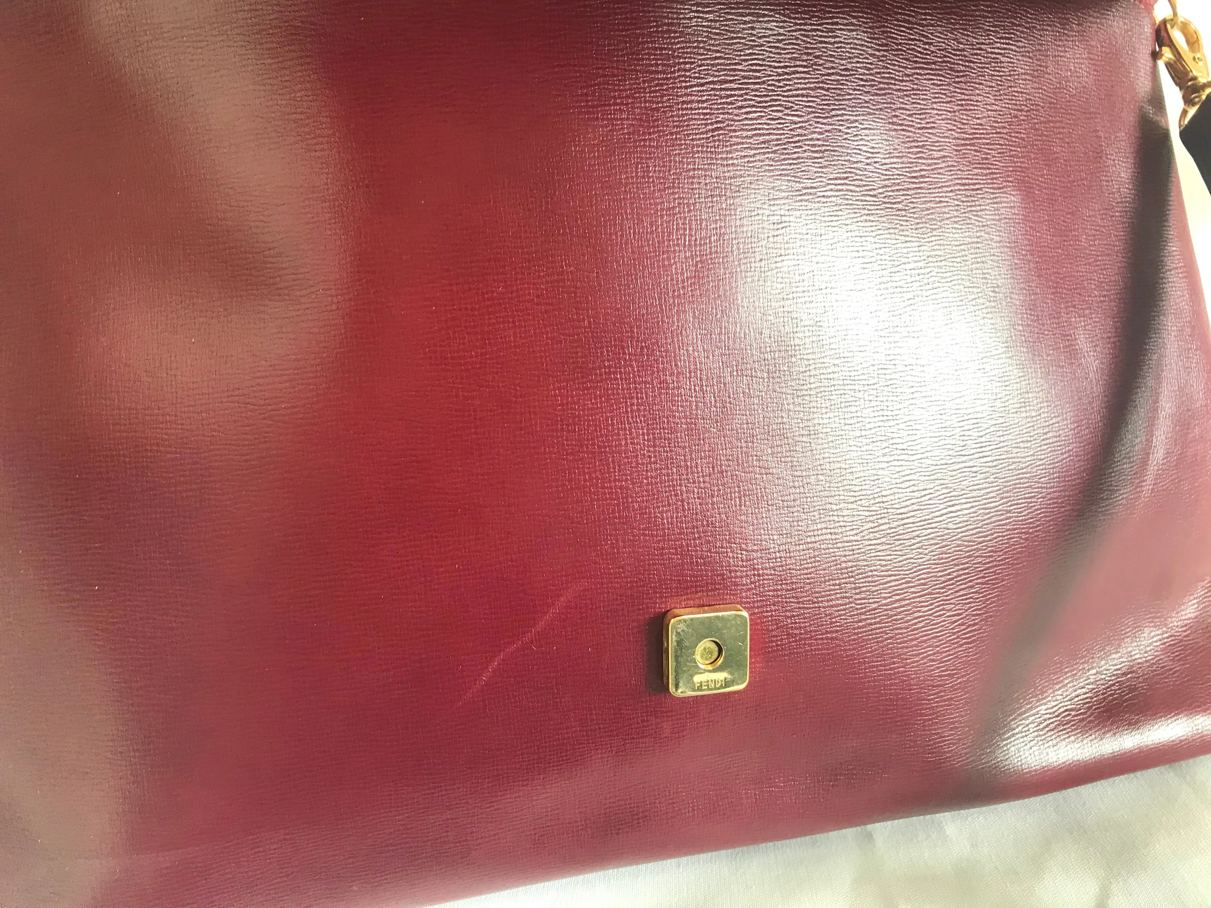 Vintage FENDI wine leather shoulder bag, large clutch purse with iconic Janus medallion embossed motifs at front. Unisex. 060620re5