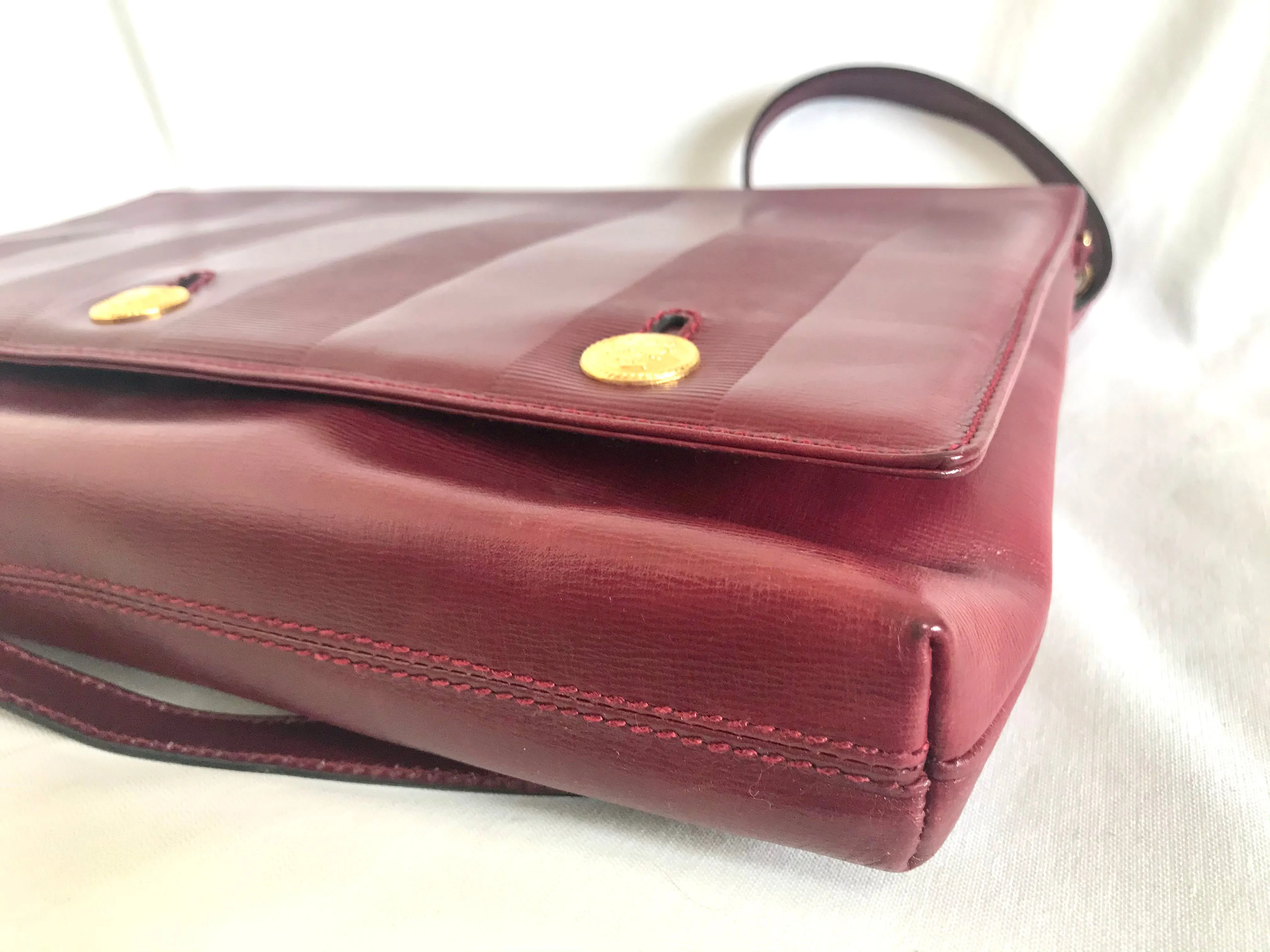 Vintage FENDI wine leather shoulder bag, large clutch purse with iconic Janus medallion embossed motifs at front. Unisex. 060620re5